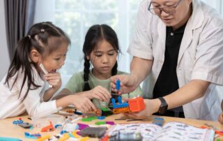 Children participating in a guided STEM building activity to enhance motor skills and problem-solving during therapy in Phnom Penh