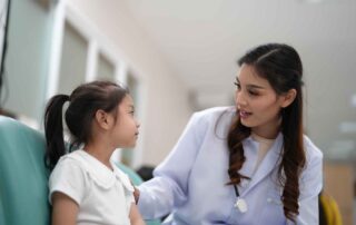 A young child interacting with a professional during a developmental assessment session at OrbRom Center in Phnom Penh.