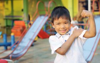 Young child engaged in therapeutic play activities to enhance motor skills at OrbRom Center Phnom Penh
