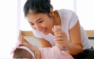 A mother engages her baby in playful interaction to support early speech and language development in Phnom Penh.