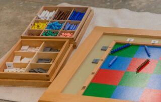 Montessori-inspired math materials including colored beads and number tiles used for hands-on early math learning at OrbRom Center in Phnom Penh.