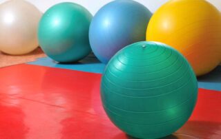Child engaging in core-strengthening activity during occupational therapy session at OrbRom Center in Phnom Penh.