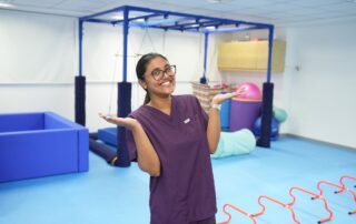 Female occupational therapist at OrbRom Center in Phnom Penh standing in sensory gym smiling confidently