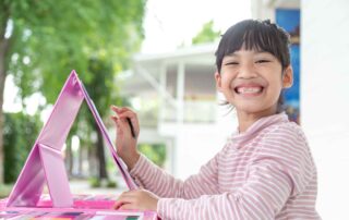 Young child engaged in painting activity as part of occupational therapy session in Phnom Penh, building fine motor skills and focus.