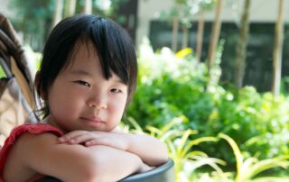 Young girl calmly resting in a stroller, representing emotional regulation and peaceful behavior supported by occupational therapy in Phnom Penh.